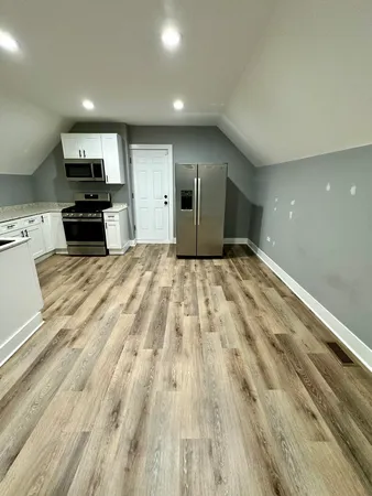a view of kitchen with microwave and cabinets