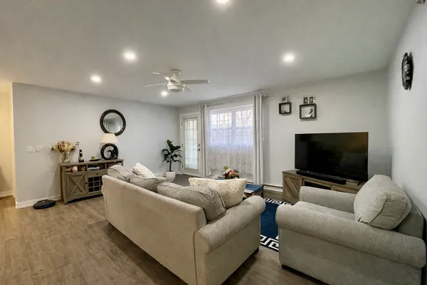 a living room with furniture and a flat screen tv