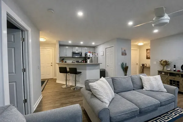 a living room with furniture and kitchen view