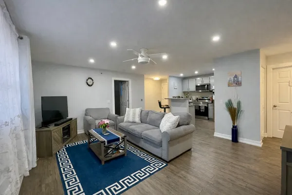 a living room with furniture and a flat screen tv