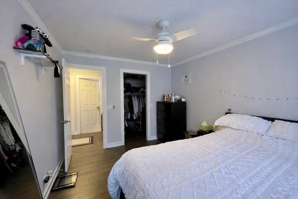 a bedroom with a bed and a chandelier