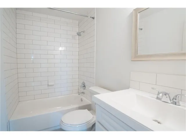 a bathroom with a sink a toilet and bathtub