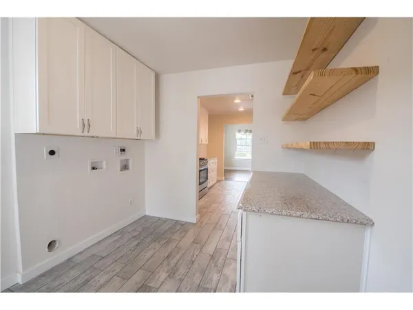 a bathroom with a granite countertop sink and mirror