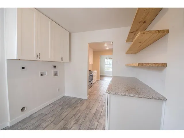 a bathroom with a granite countertop sink and mirror