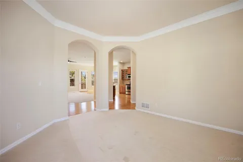 a view of a room with wooden floor and a white wall