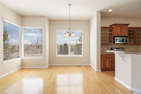 a kitchen with a refrigerator a stove top oven a sink and dishwasher with wooden floor