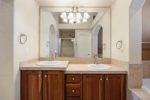 a bathroom with a double vanity sink and a mirror