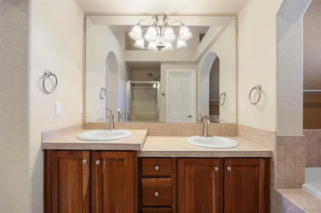a bathroom with a double vanity sink and a mirror