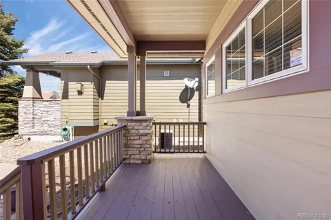 a view of a balcony with wooden floor and fence