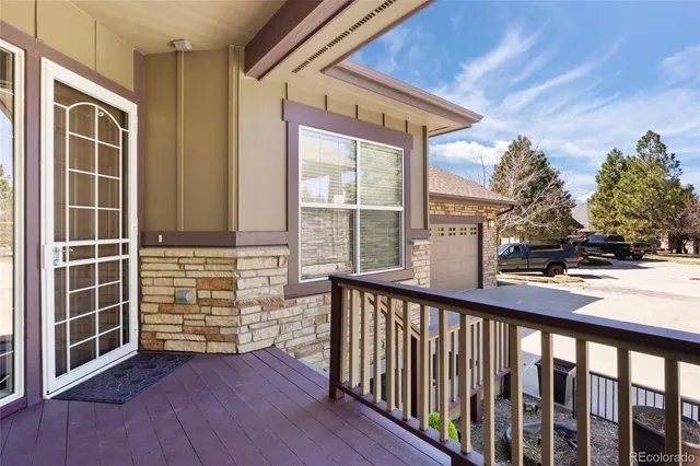 a view of a porch with a floor to ceiling window and wooden floor
