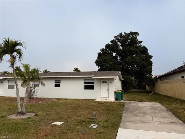 a view of a house with a yard and tree s