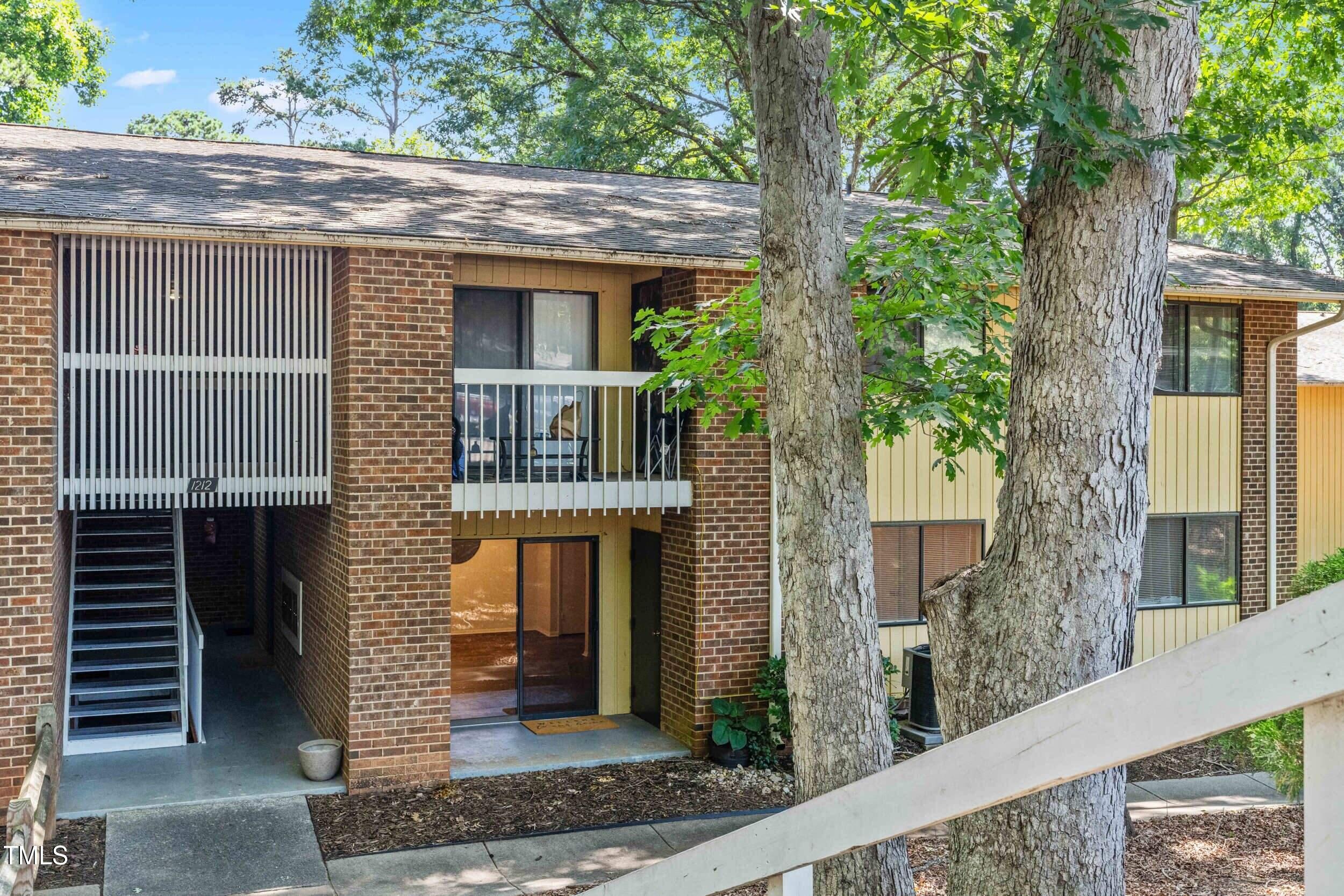 1212 Schaub Drive, Unit C Raleigh, NC 27606 - Photo 1 of 23 a front view of a house with garden