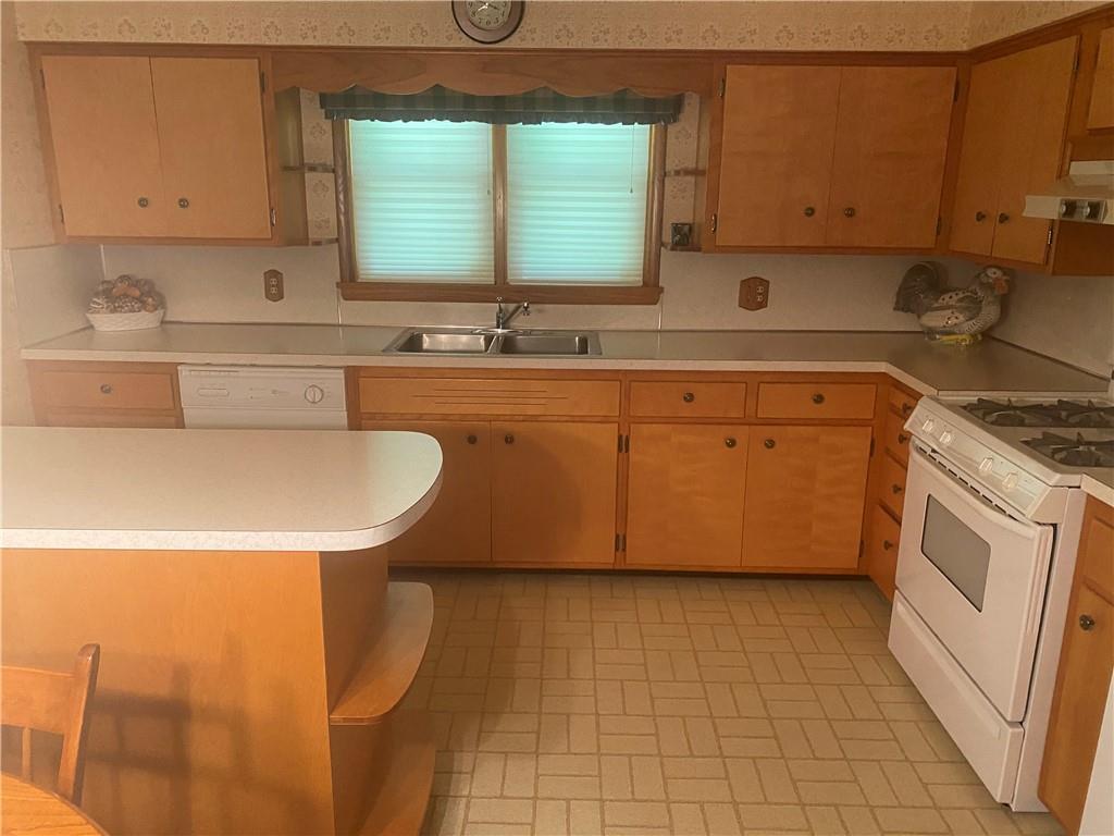 201 College Lodge Road Indiana, PA 15701 - Photo 6 of 20 a kitchen with stainless steel appliances a sink a stove a refrigerator and cabinets
