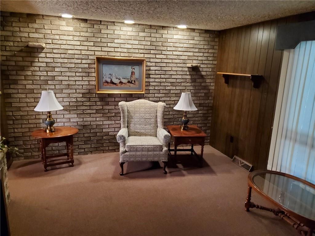 201 College Lodge Road Indiana, PA 15701 - Photo 8 of 20 a hallway with chairs and a potted plant