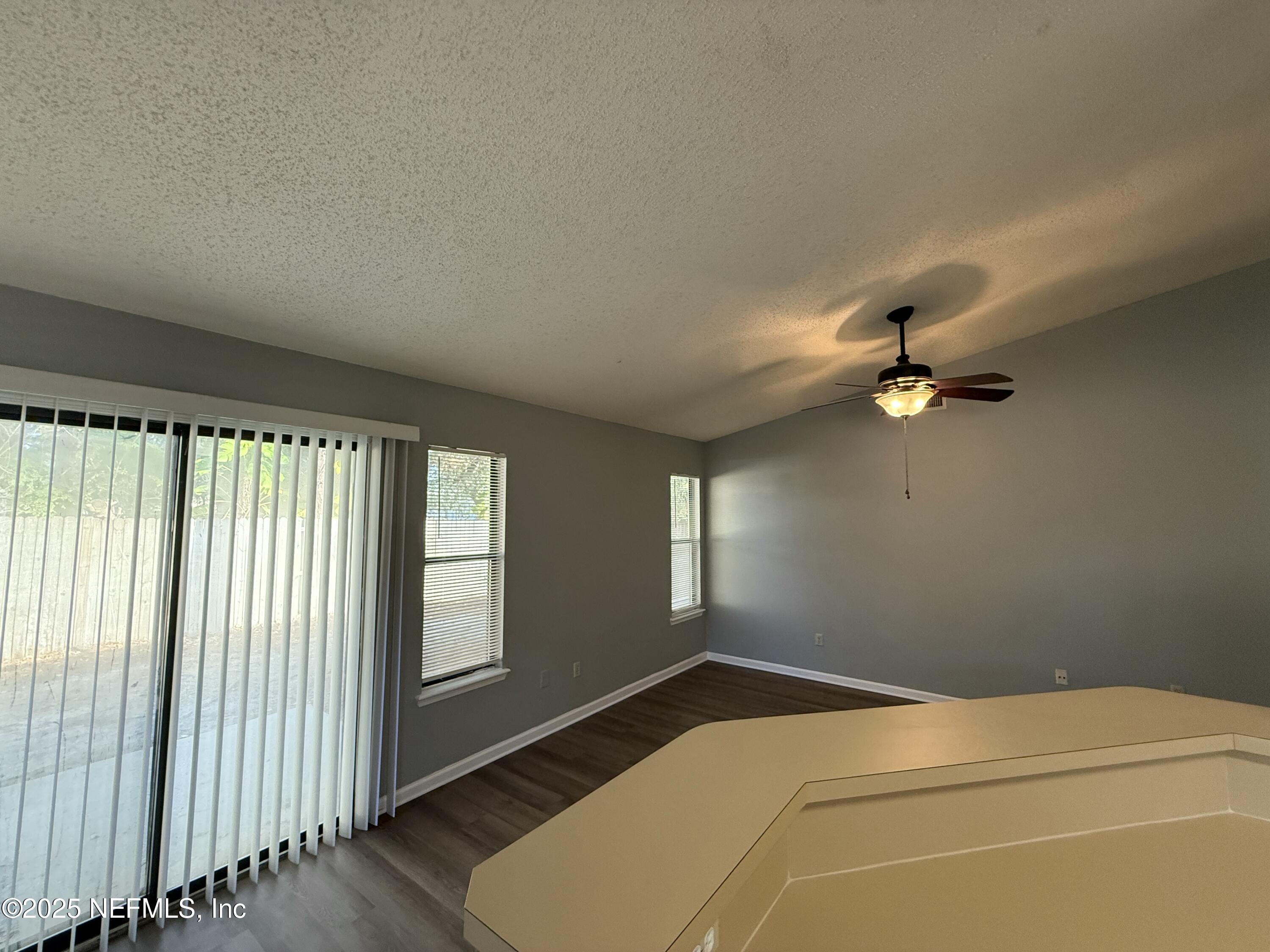 325 Quebec Lane Jacksonville, FL 32225 - Photo 11 of 24 a bedroom with a bed and a ceiling fan