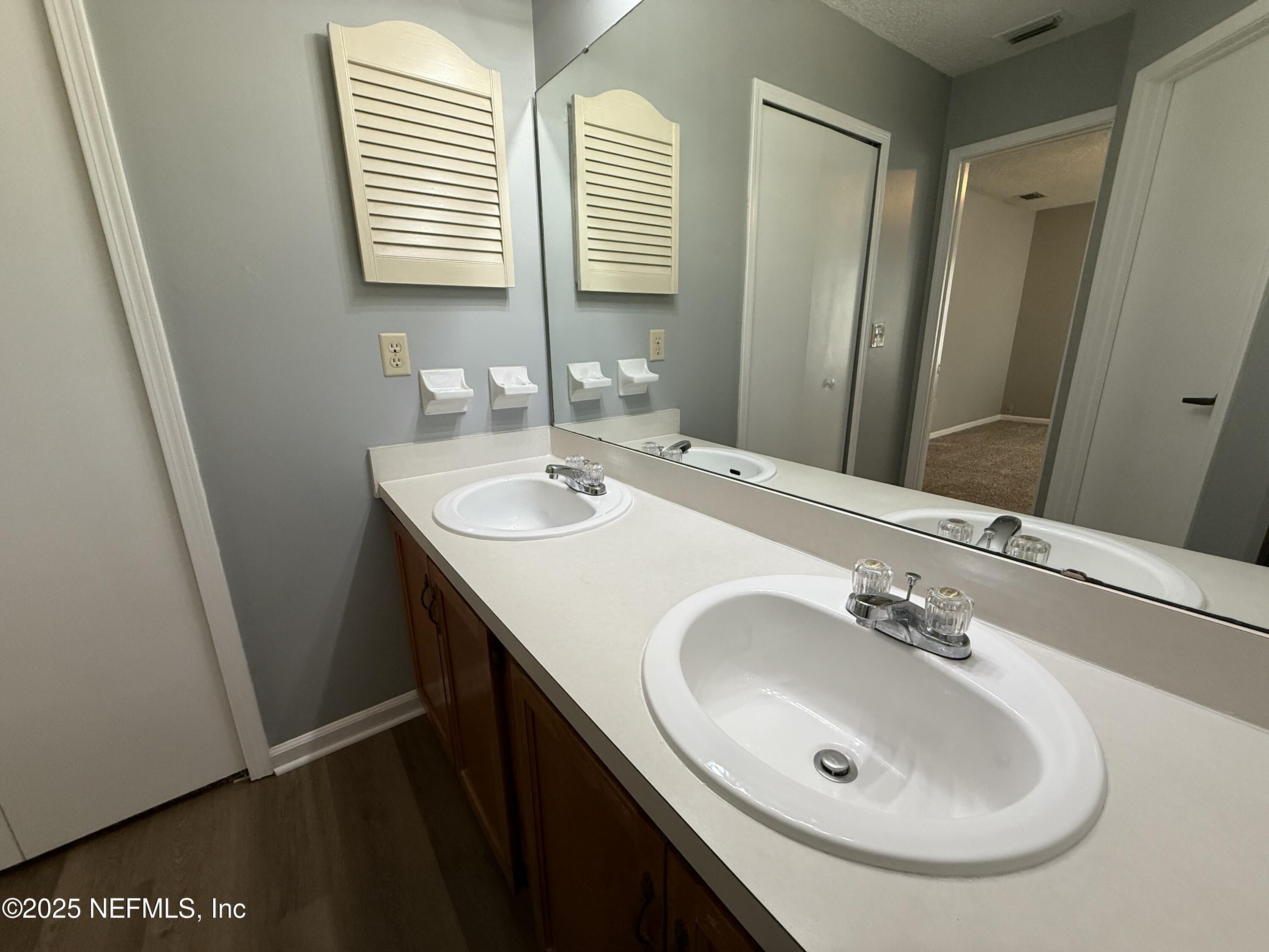 325 Quebec Lane Jacksonville, FL 32225 - Photo 13 of 24 a bathroom with a sink and a mirror