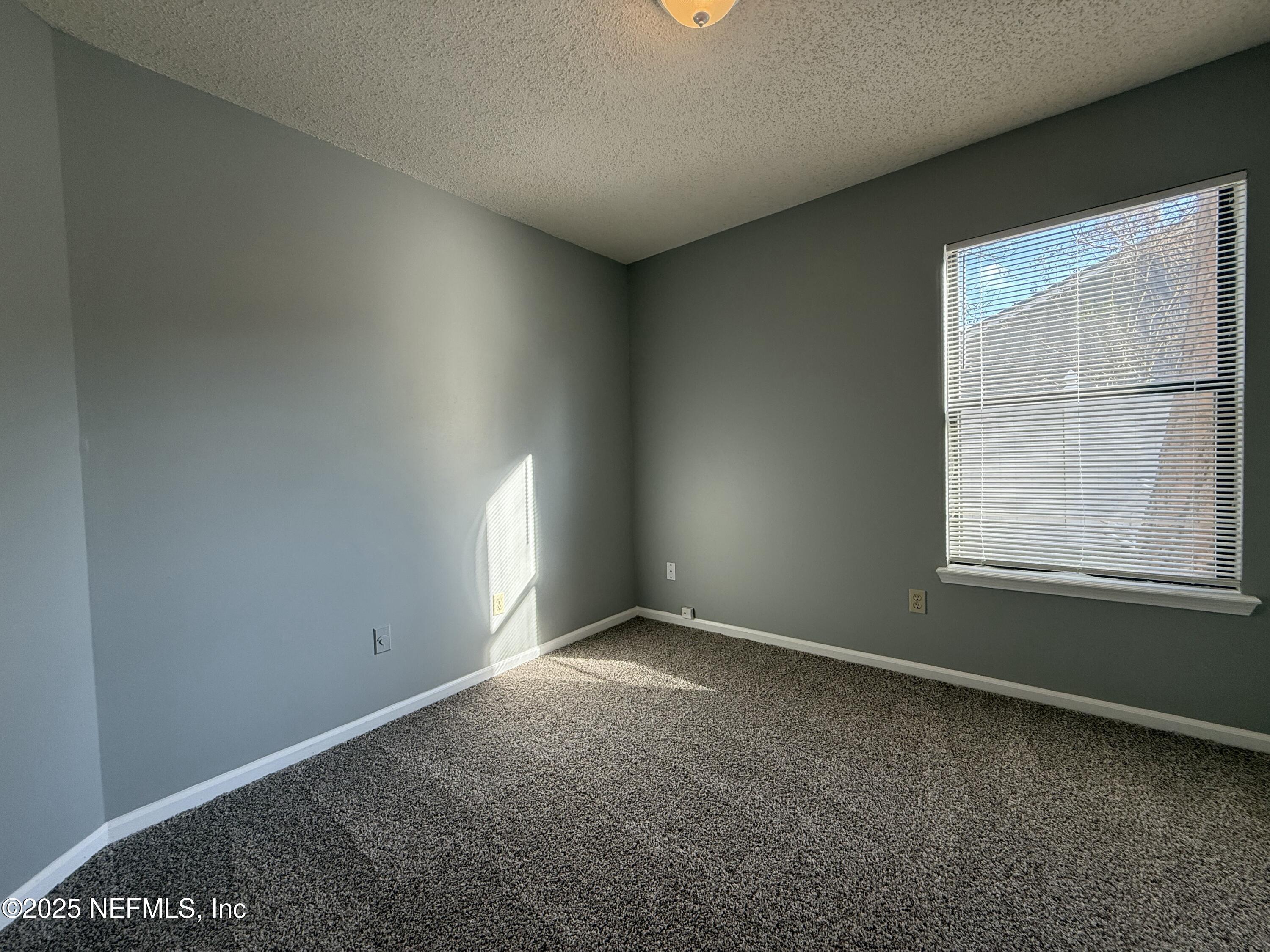 325 Quebec Lane Jacksonville, FL 32225 - Photo 14 of 24 an empty room with a window