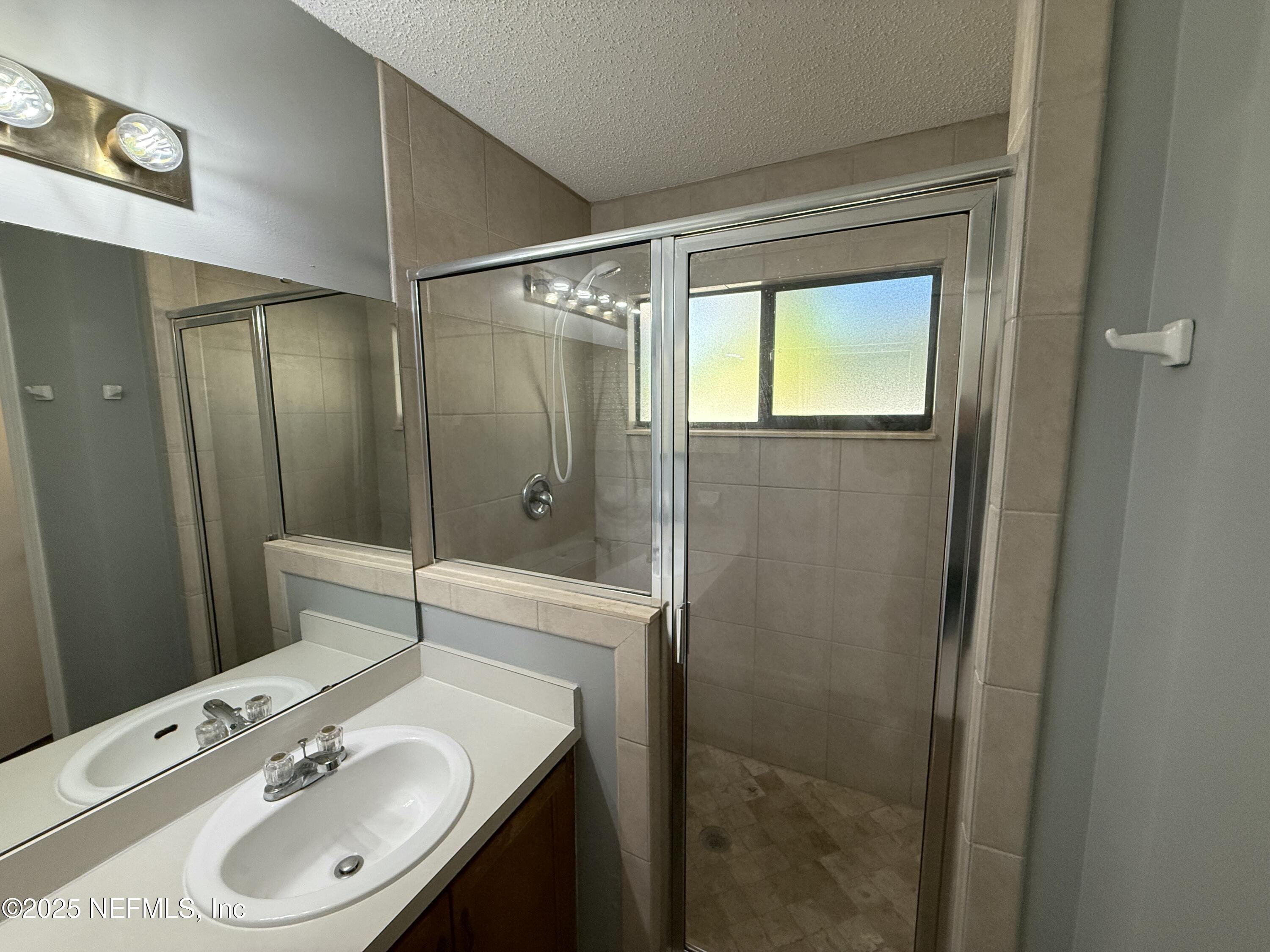 325 Quebec Lane Jacksonville, FL 32225 - Photo 20 of 24 a bathroom with a sink a toilet and shower
