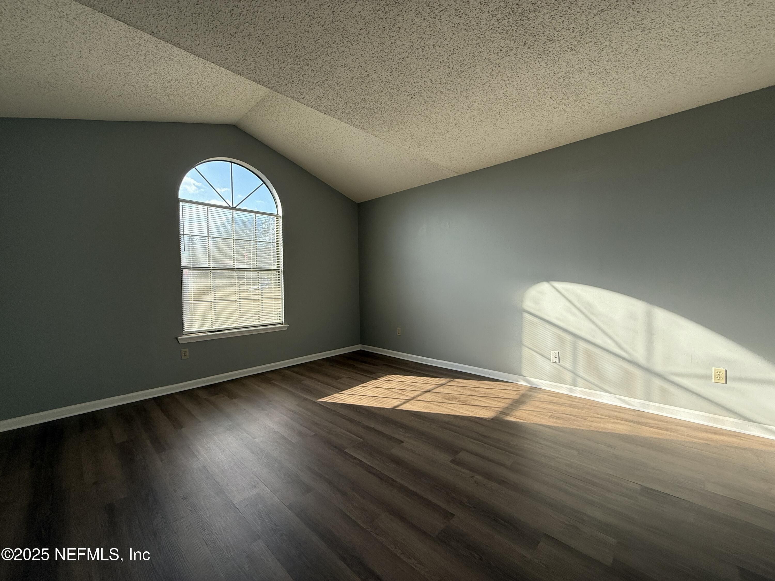 325 Quebec Lane Jacksonville, FL 32225 - Photo 2 of 24 an empty room with wooden floor and windows