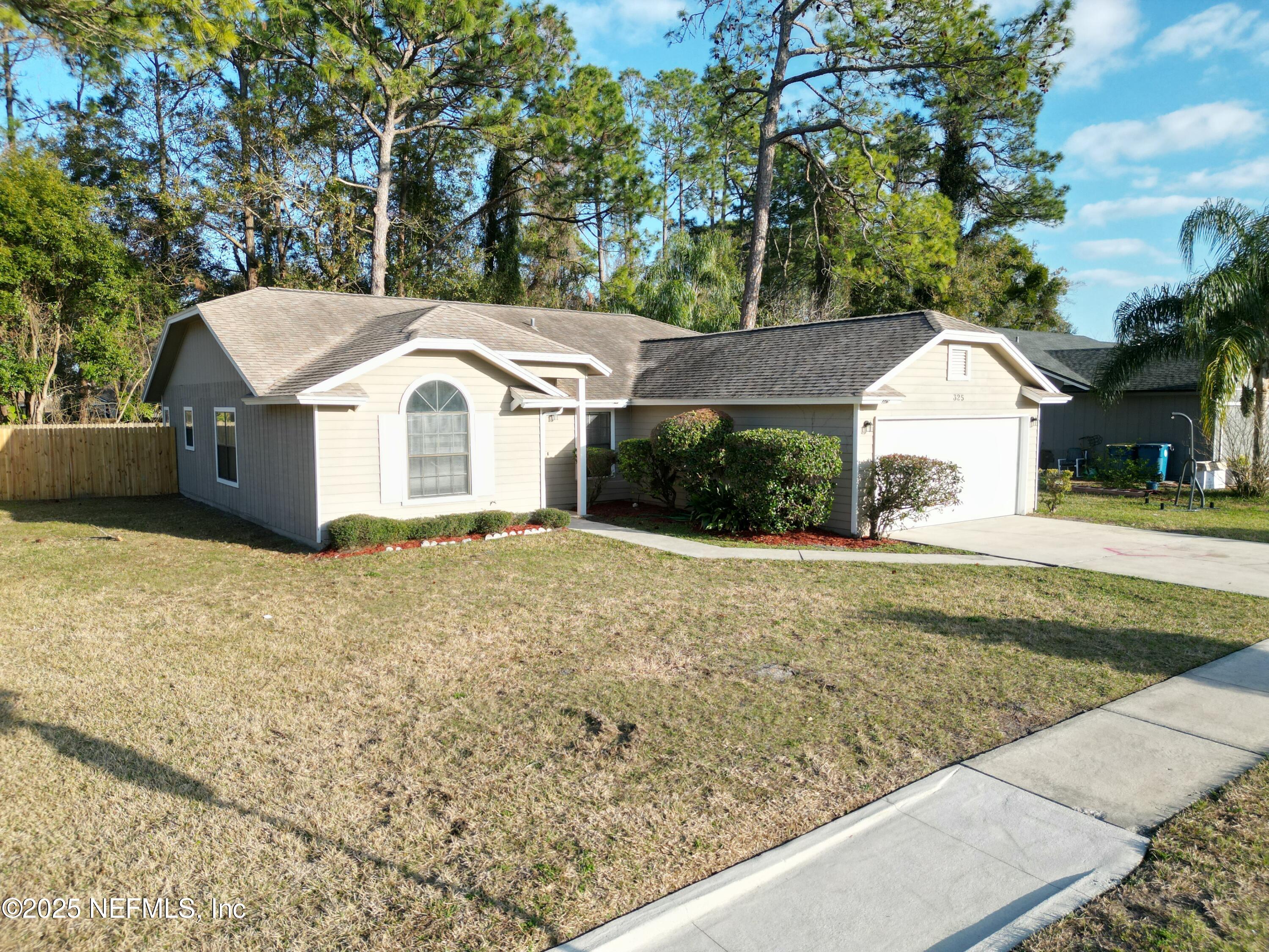 325 Quebec Lane Jacksonville, FL 32225 - Photo 23 of 24 a front view of a house with a yard and large tree