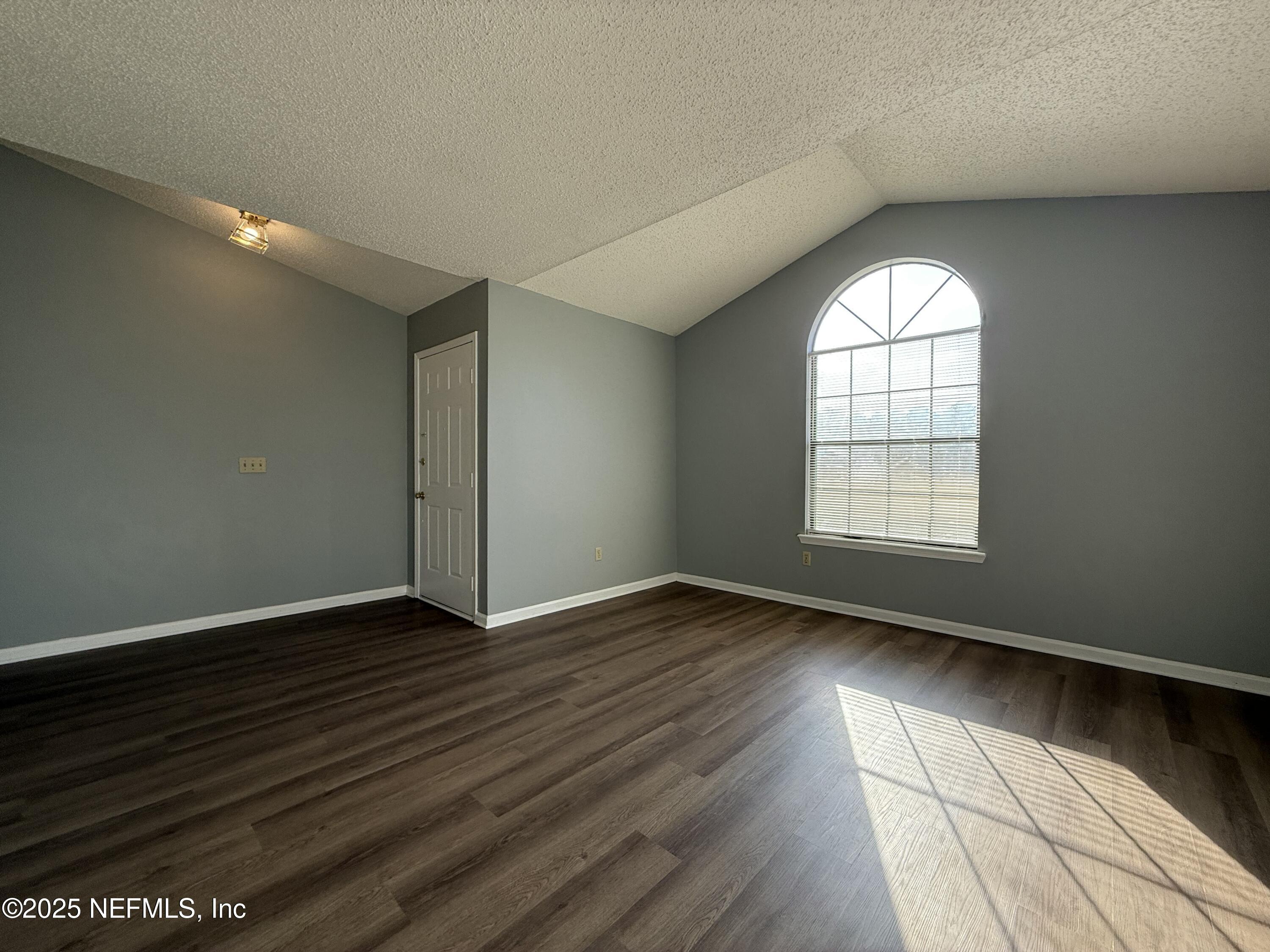 325 Quebec Lane Jacksonville, FL 32225 - Photo 3 of 24 an empty room with wooden floor and windows