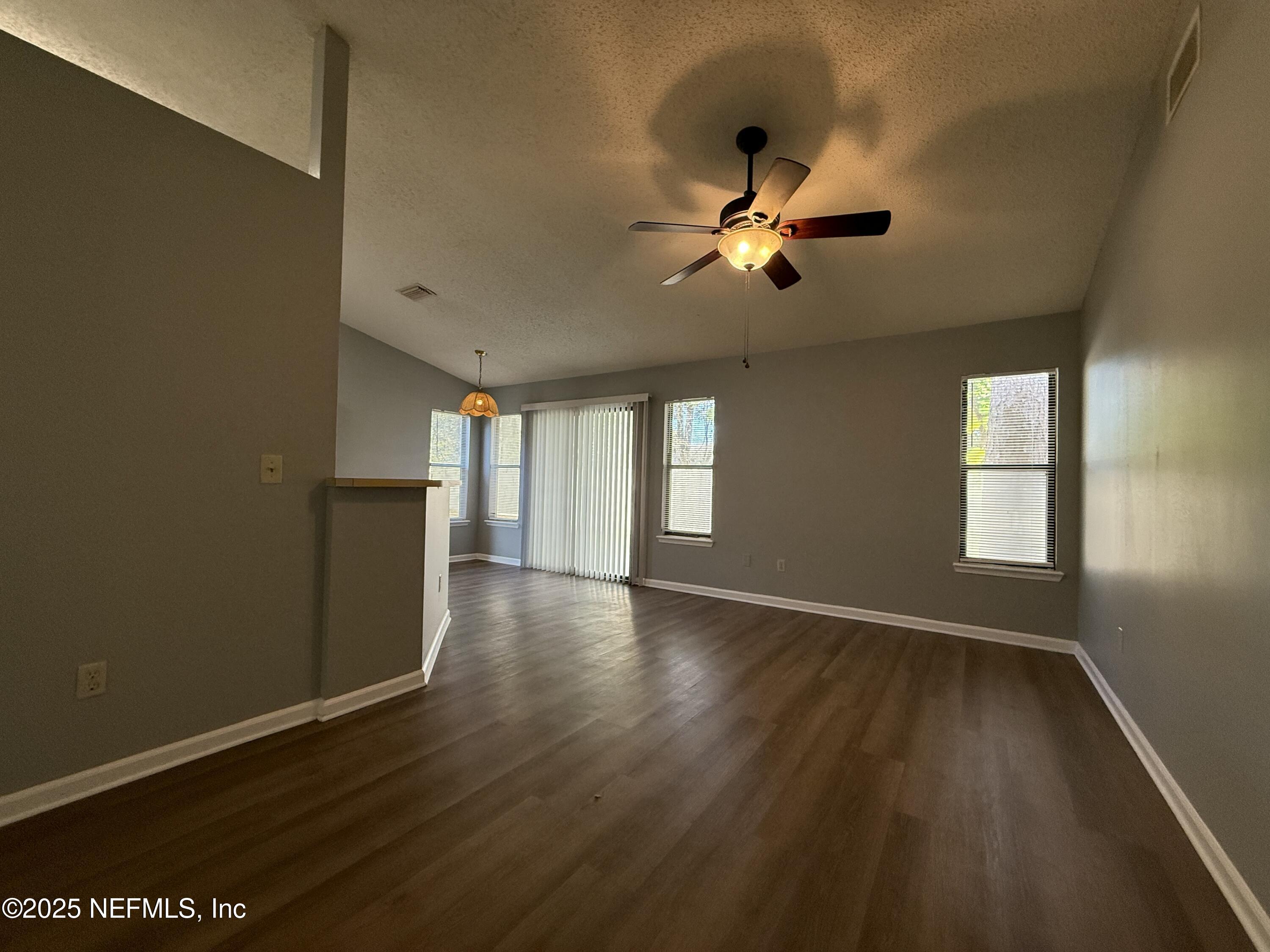 325 Quebec Lane Jacksonville, FL 32225 - Photo 5 of 24 a view of an empty room with a window and wooden floor