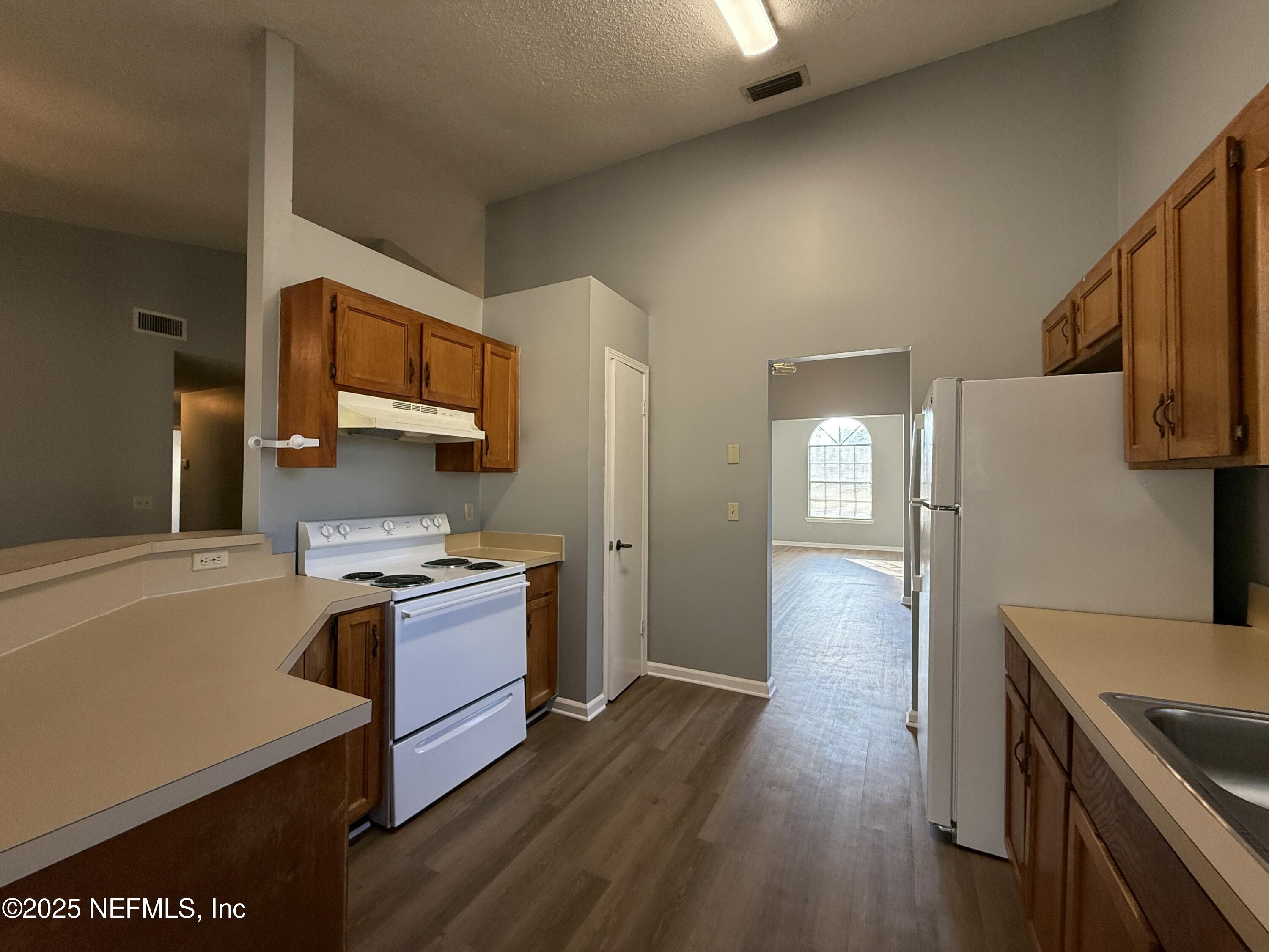 325 Quebec Lane Jacksonville, FL 32225 - Photo 8 of 24 a kitchen with stainless steel appliances granite countertop a sink stove and refrigerator