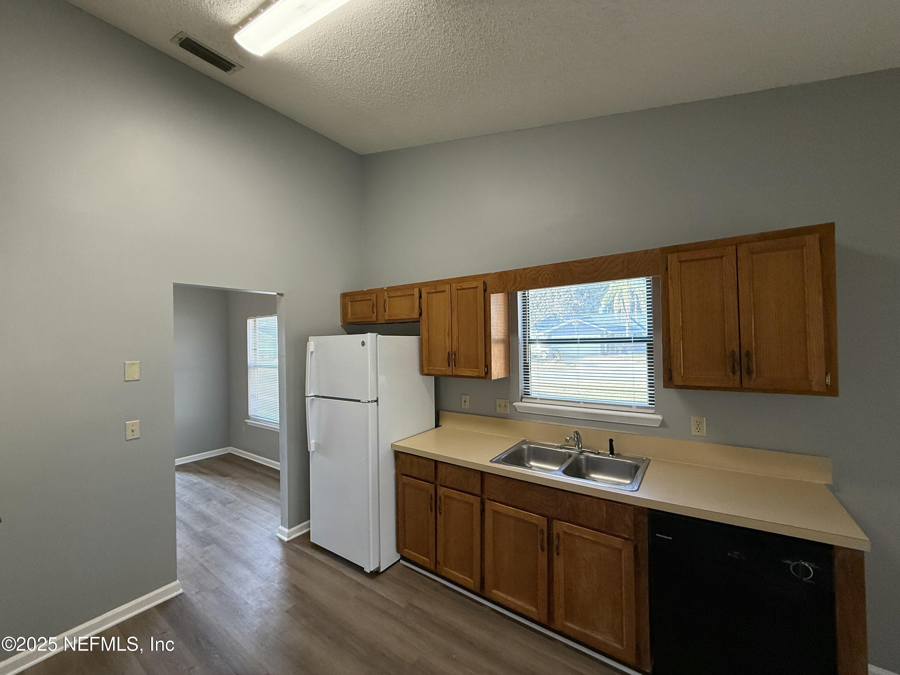 325 Quebec Lane Jacksonville, FL 32225 - Photo 10 of 24 a kitchen with a sink cabinets stainless steel appliances and a window