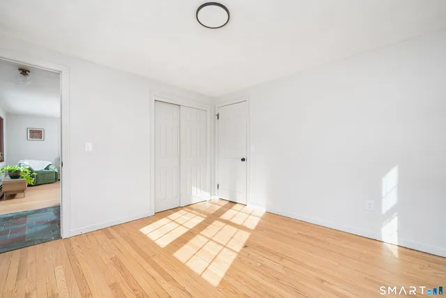 a bathroom with a granite countertop sink a toilet and a mirror