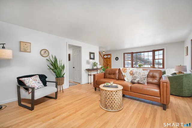 a living room with furniture a fireplace and a potted plant