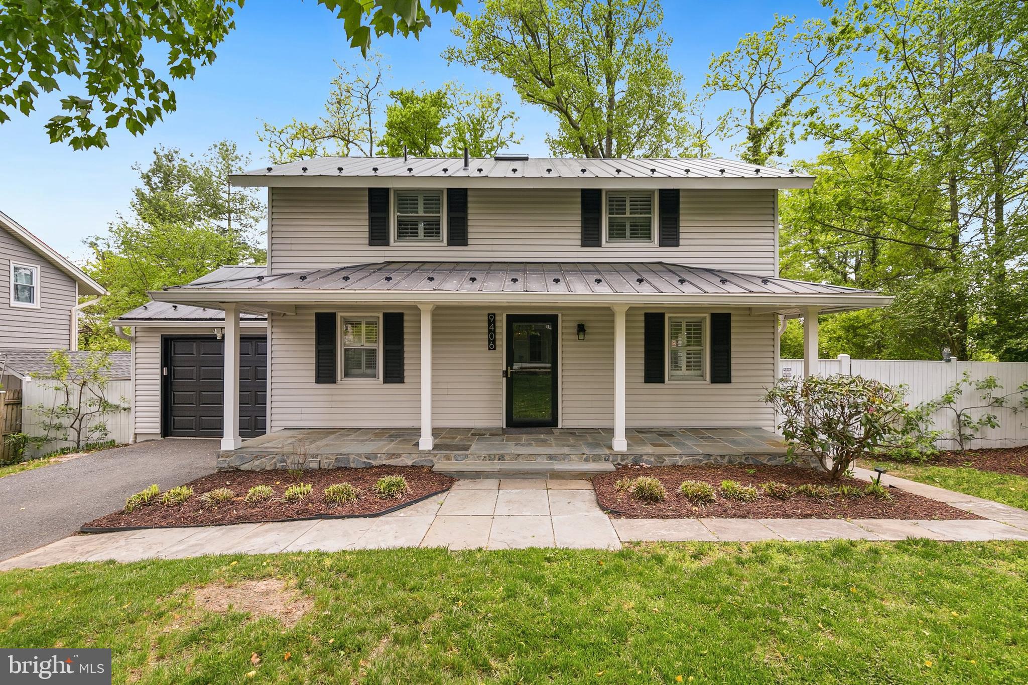a front view of a house with yard and green space