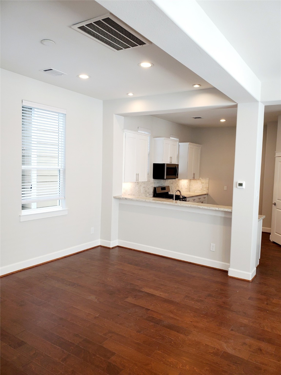 720 C Link Road Houston, TX 77009 - Photo 13 of 40 a view of kitchen with stainless steel appliances kitchen island granite countertop a stove top oven a sink and dishwasher a refrigerator with wooden floor