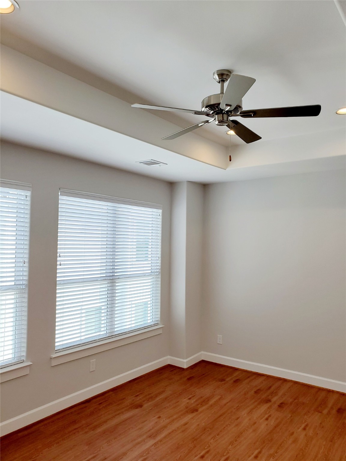 720 C Link Road Houston, TX 77009 - Photo 19 of 40 an empty room with wooden floor fan and windows