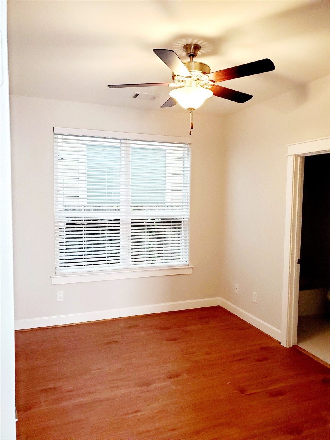 720 C Link Road Houston, TX 77009 - Photo 28 of 40 a view of an empty room with wooden floor and a window