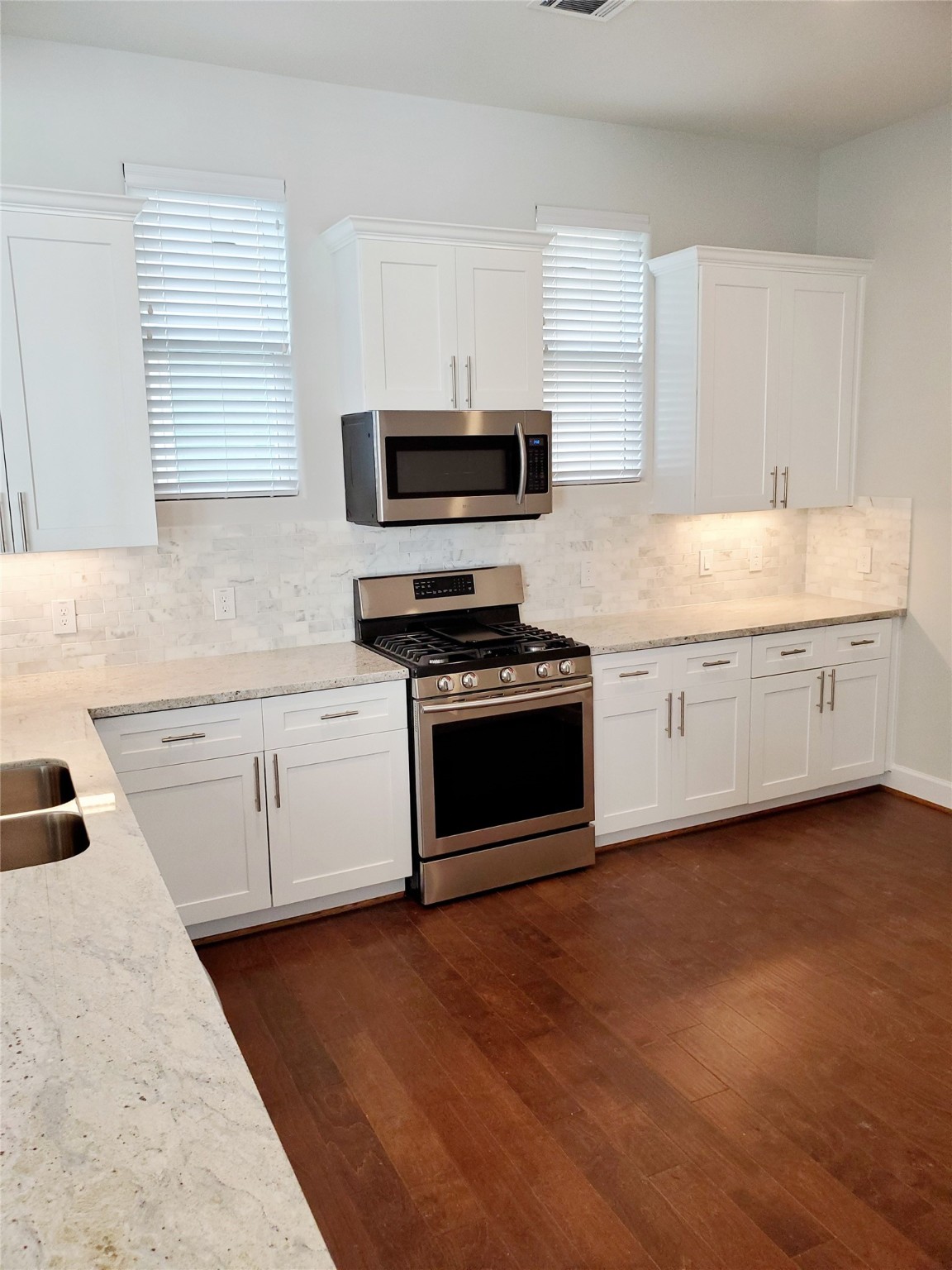 720 C Link Road Houston, TX 77009 - Photo 8 of 40 a kitchen with granite countertop cabinets stainless steel appliances and a sink