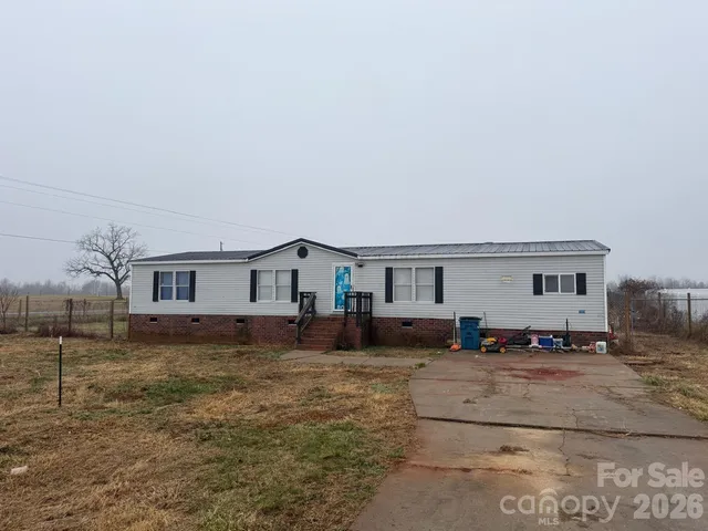 a view of a house with a large tree in front of a house