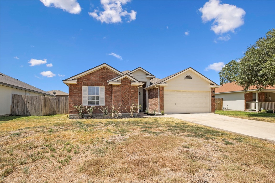 353 Leonardo Kyle, TX 78640 - Photo 1 of 1 a view of a house with a yard and garage