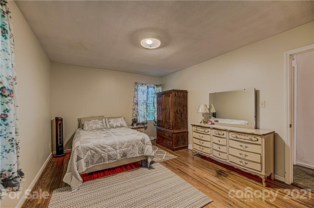 11328 Torino Road Matthews, NC 28105 - Photo 12 of 23 a bedroom with a bed and a dresser