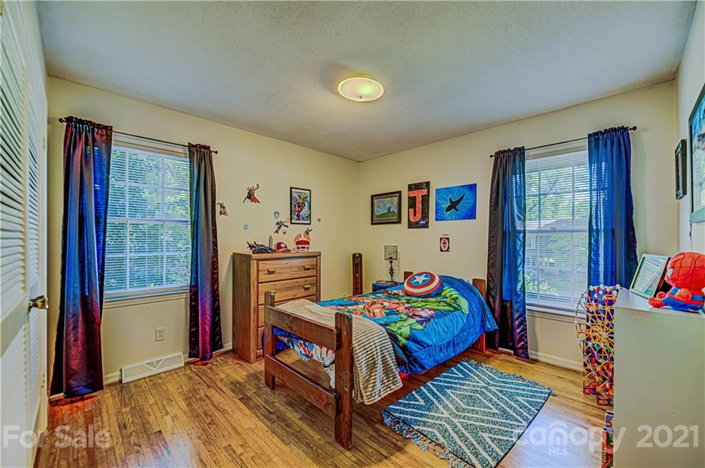 11328 Torino Road Matthews, NC 28105 - Photo 16 of 23 a bedroom with a bed and wooden floor
