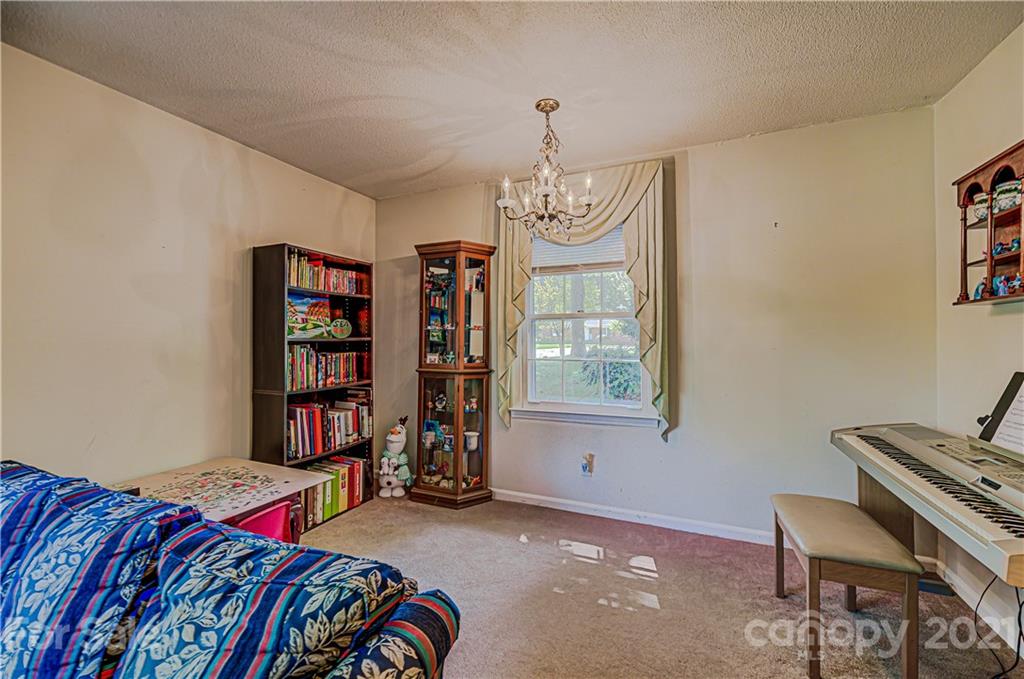 11328 Torino Road Matthews, NC 28105 - Photo 5 of 23 a bedroom with a bed and a book shelf