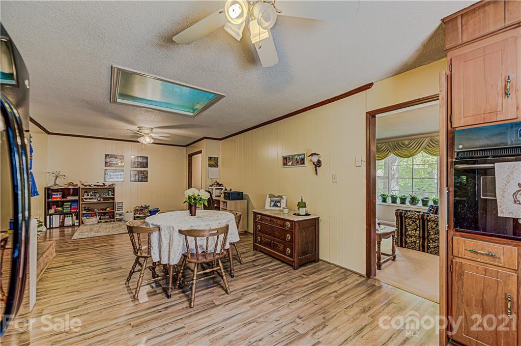 11328 Torino Road Matthews, NC 28105 - Photo 9 of 23 a view of a dining room with furniture window and wooden floor