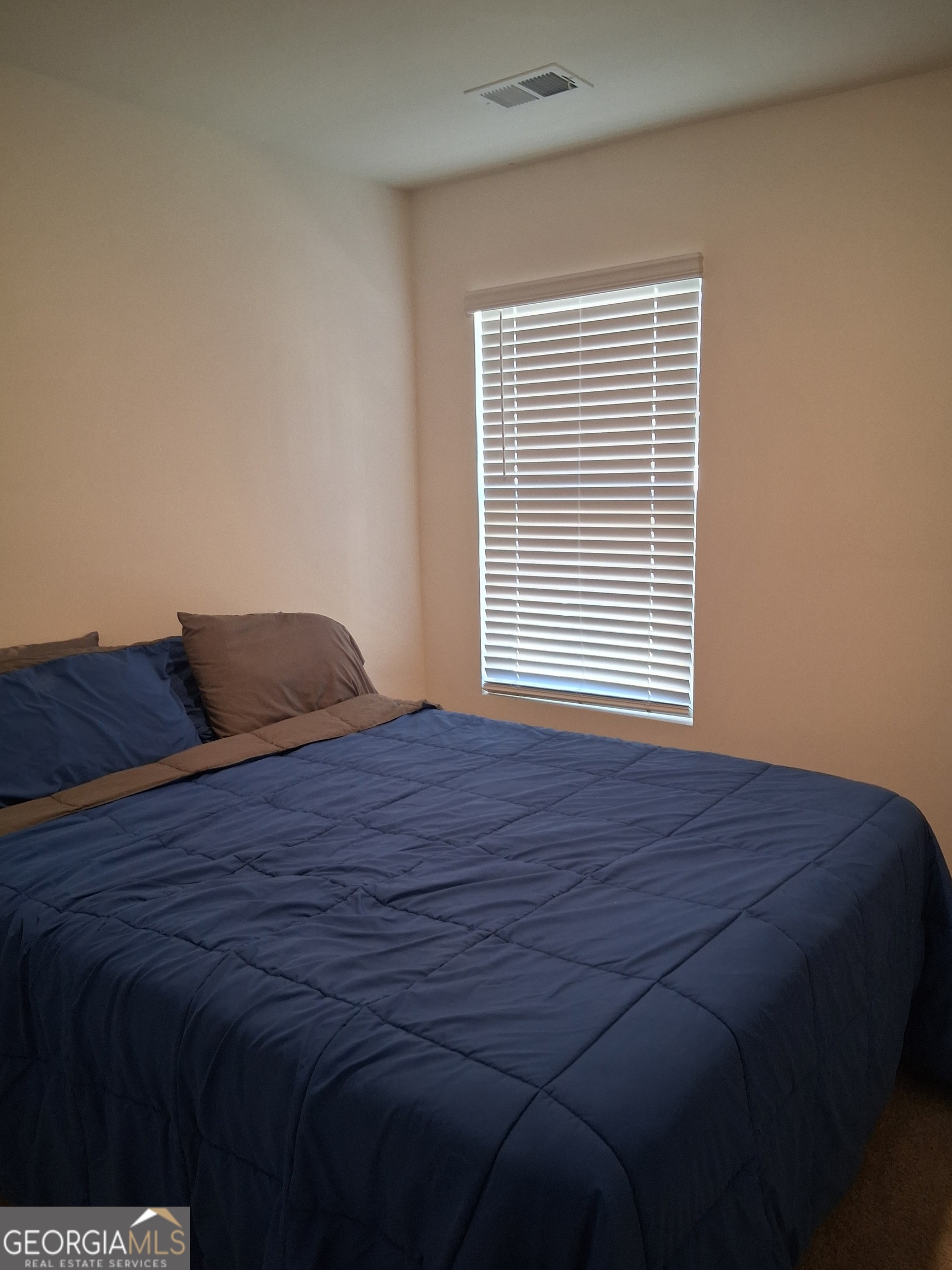 2685 Paxton Place Decatur, GA 30034 - Photo 14 of 17 a bed sitting in a bedroom next to a window