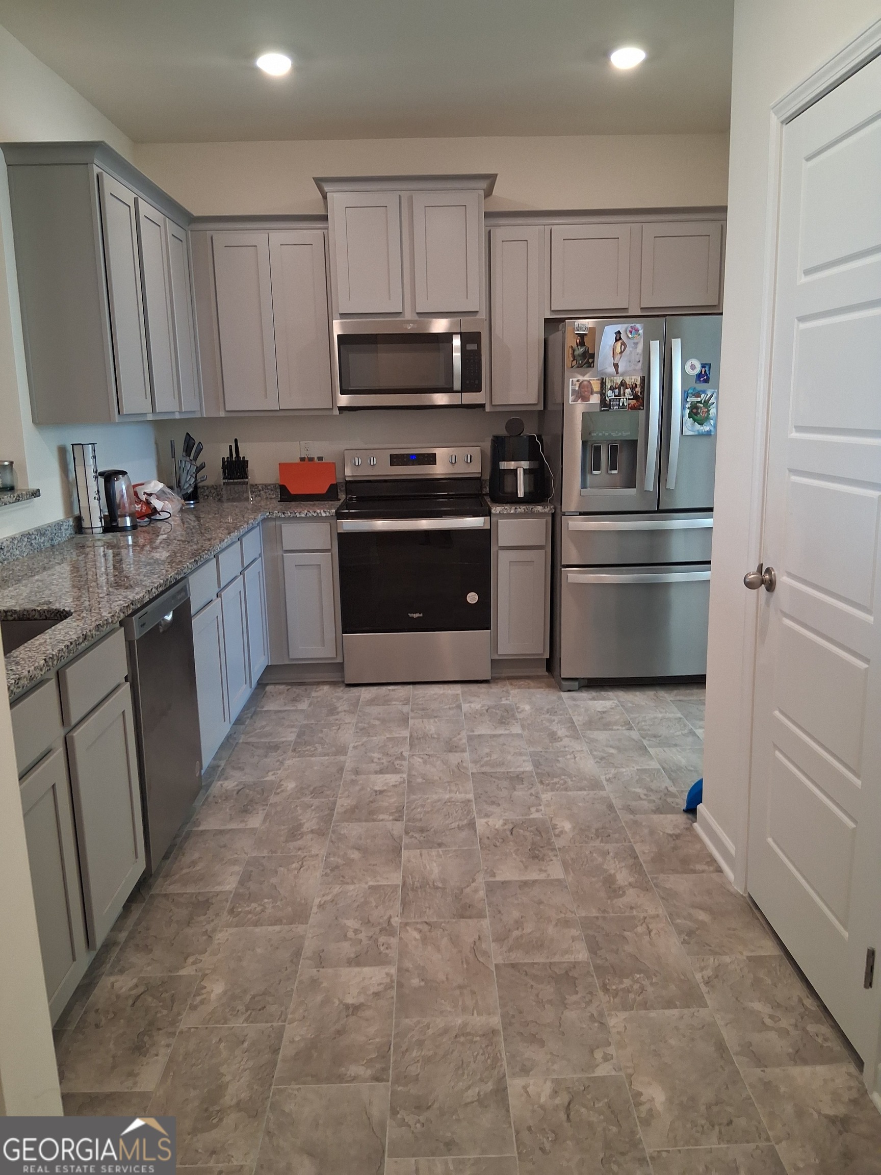 2685 Paxton Place Decatur, GA 30034 - Photo 5 of 17 a kitchen with granite countertop a refrigerator and a stove top oven
