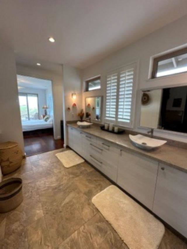 1141 Lower Kimo Drive Kula, HI 96790 - Photo 16 of 34 a spacious bathroom with a granite countertop sink and a large mirror