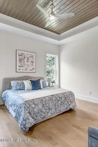 a living room with a bed furniture and next to a window