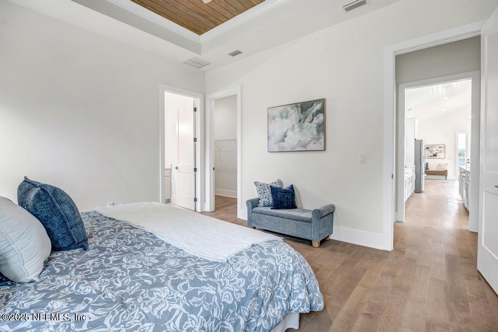 552 Seagate Avenue Neptune Beach, FL 32266 - Photo 17 of 29 a bedroom with a bed and wooden floor