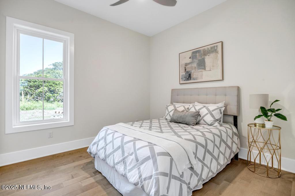 552 Seagate Avenue Neptune Beach, FL 32266 - Photo 19 of 29 a bedroom with a large bed and a window