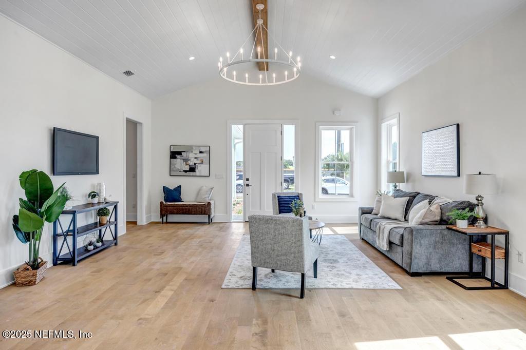 552 Seagate Avenue Neptune Beach, FL 32266 - Photo 2 of 29 a living room with furniture and a chandelier