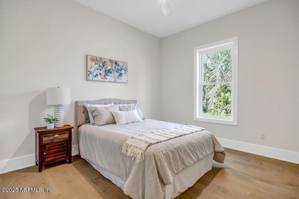 552 Seagate Avenue Neptune Beach, FL 32266 - Photo 23 of 29 a bedroom with a bed and a window