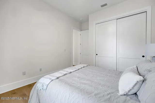 a bedroom with a bed and a night stand